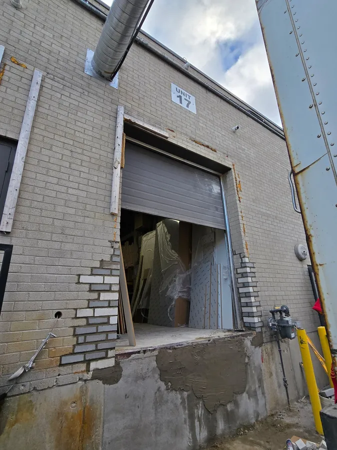 Loading dock opening being rebuilt with new brick jambs and patched concrete dock face