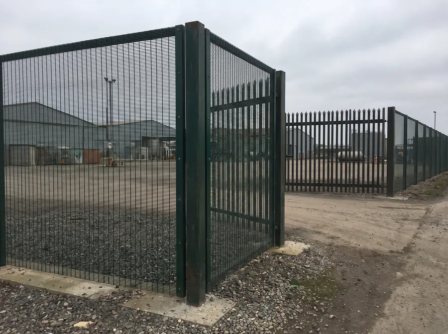 Heavy-gauge anti-climb welded mesh security fencing with a palisade section beyond
